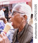 Woman eating ice cream  near hotel  Windsor castle England United Kingdom dated May 19,2024