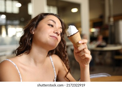 Woman Eating An Ice Cream Sitting In A Coffee Shop Interior