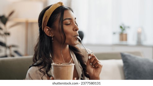 Woman, eating ice cream and sofa in house, thinking or idea for dessert, sweets or relax in living room. Girl, gelato or frozen yogurt for snack, lounge couch and home with memory, choice or decision