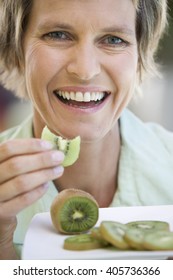 A Woman Eating Kiwi Fruit