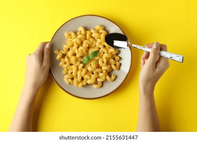 Woman Eating Macaroni With Cheese On Yellow Background, Top View