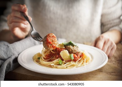 Woman eating meatballs horizontal