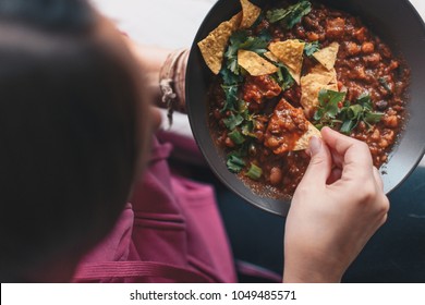 Woman Eating Mexican Food With Nachos Viewed Directly From Above