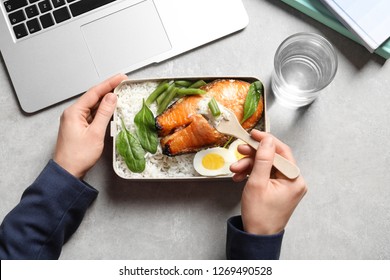 Woman Eating Natural Protein Food From Container At Office Table, Top View