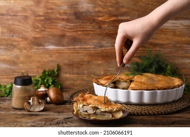 Woman Eating Piece Of Tasty Chicken Pot Pie On Wooden Background