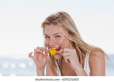 Woman Eating Popsicle On Beach