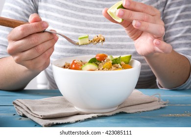 Woman Eating Quinoa And Vegetables
