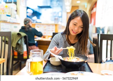 Woman Eating Ramen In Japanese Ramen Shop