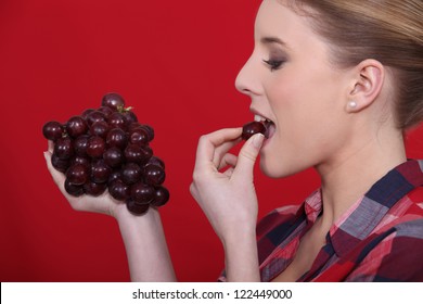 Woman Eating Red Grapes