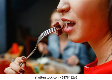 The Woman Is Eating Roasted Meat.