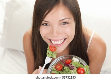 Woman Eating Salad. Portrait Of Beautiful Smiling And Happy Mixed Asian Caucasian Woman Enjoying A Healthy Salad And Cherry Tomatoes Snack.