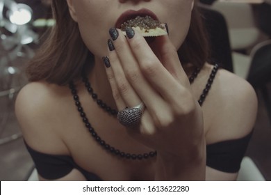 Woman Eating A Sandwich With Black Caviar.