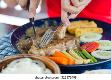 Woman eating steak