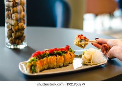 Woman eating sushi at a restaurant