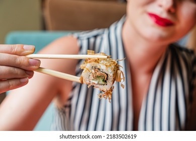 Woman Eating Sushi In The Restaurant