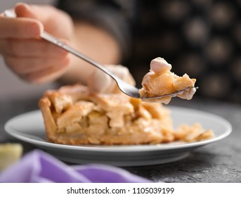 Woman Eating Tasty Apple Pie In Kitchen