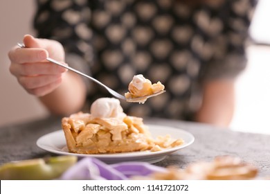 Woman Eating Tasty Apple Pie In Kitchen