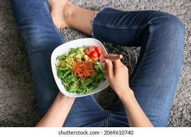 Woman Eating Tasty Arugula Salad, Closeup