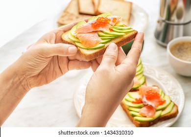 Woman Eating Tasty Avocado Toast, Closeup