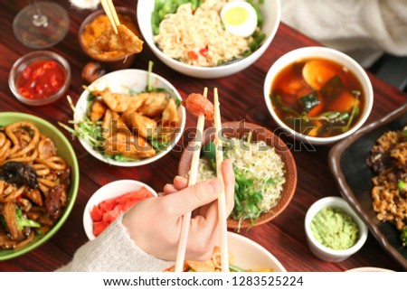 Woman eating tasty Chinese food, closeup
