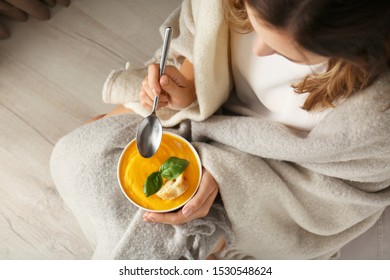 Woman Eating Tasty Cream Soup At Home