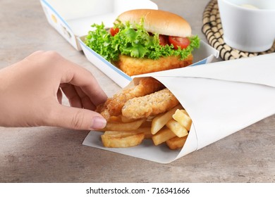 Woman Eating Tasty Fried Fish And Chips, Closeup