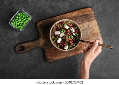 Woman Eating Tasty Lentils With Beans And Cheese, Top View