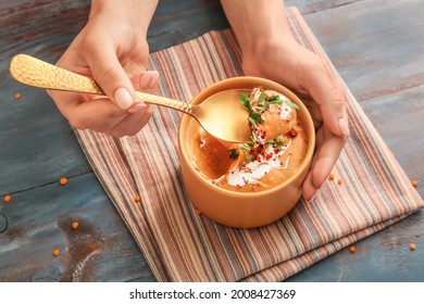 Woman Eating Tasty Lentils Soup From Bowl On Table