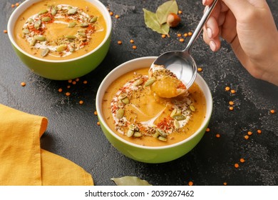 Woman Eating Tasty Lentils Soup From Bowl On Table