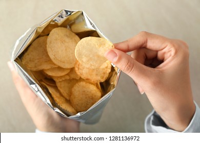 Woman Eating Tasty Potato Chips, Closeup