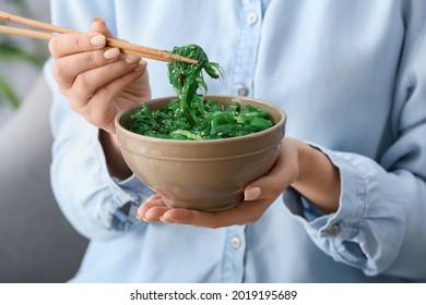 Woman Eating Tasty Seaweed Salad, Closeup