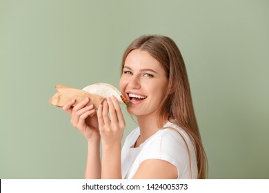 Woman Eating Tasty Taco On Color Background