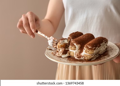 Woman Eating Tasty Tiramisu On Color Background