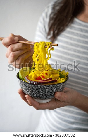 Woman eating thai noodles
