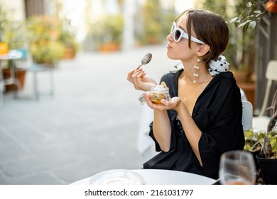 Woman Eating Tiramisu Dessert At The Restaurant Outdoors. Concept Of Italian Cuisine