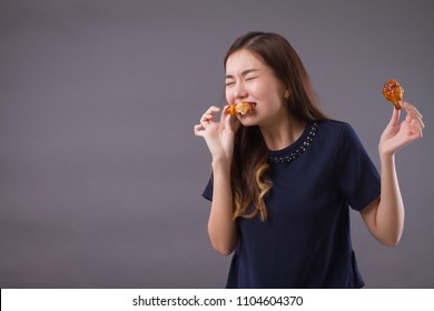 Woman Eating Unhealthy Fat Fried Chicken; Portrait Of Unhealthy Girl Eating Fat Fried Chicken, Fast Food; Unhealthy Eating, Dining With High Cholesterol Fat Concept; Asian Chinese 20s Woman Model