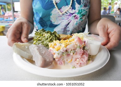 Woman Eats Cook Island Potato Salad (Mainese) Traditional Dish Served In A Plate In Rarotonga Night Market In Cook Islands. Food Background And Texture. Copy Space