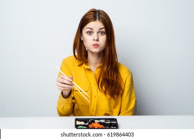 A Woman Eats, A Woman Is Distracted From Eating