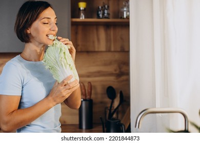 Woman Eats Salat At The Kitchen