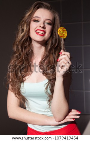 woman eats sweet candy lollipop