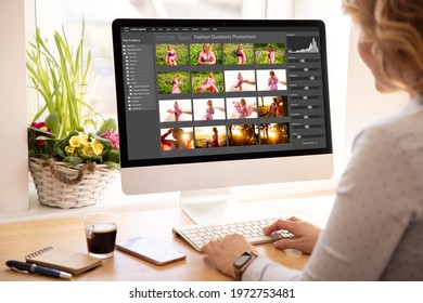Woman editing digital photos on desktop computer
