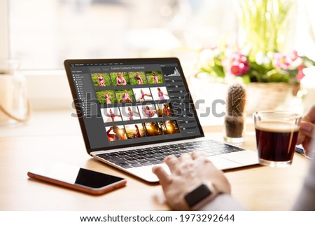 Woman editing digital photos on laptop computer