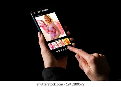 Woman Editing Her Photos On Mobile Phone, Applying Different Photo Filters To An Image