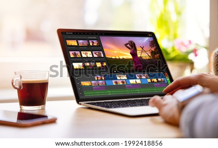 Woman editing video footage on laptop computer