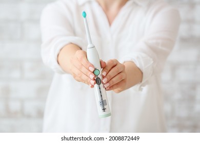 Woman With Electric Toothbrush, Closeup