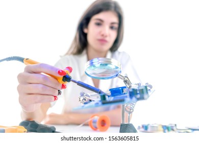 Woman Electronic Technician Repair Electronic Equipment using Electric Soldering Iron - Powered by Shutterstock