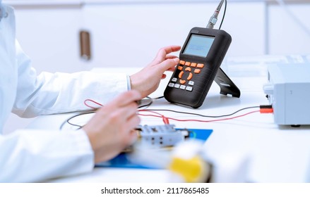 Woman Electronics Laboratory Measures Multimeter Circuit Board Parameters