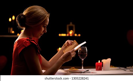 Woman In Elegant Dress Looking At Restaurant Bill, Having Dinner Alone, Break Up