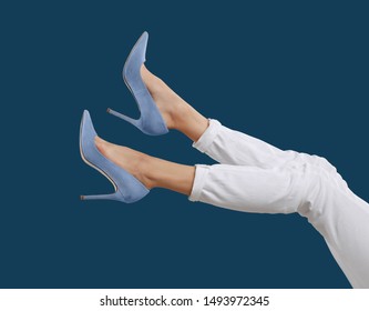 Woman in elegant shoes on dark blue background