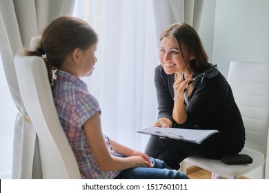 Woman Elementary School Teacher Testing Talking To Girl. Education, Individual Learning, Child Psychology